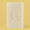 Savon beige avec un logo gravé envolé.