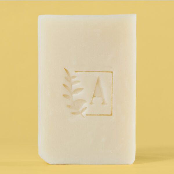 Savon beige avec un logo gravé envolé.