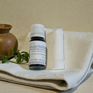 Flacon d'huiles essentielles sur tissu neutre.